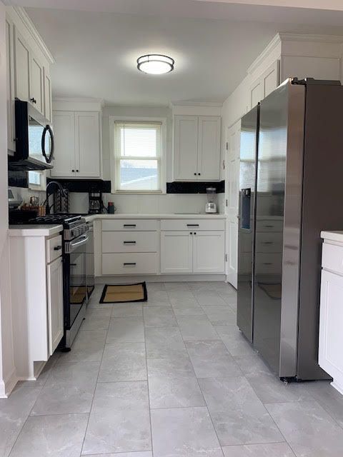 kitchen with stainless steel appliances and white cabinets