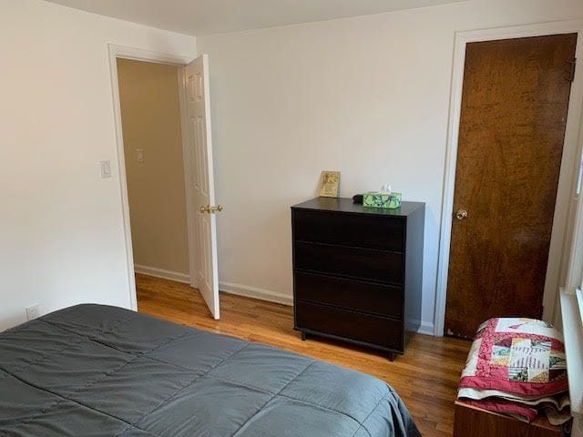 bedroom with baseboards and wood finished floors