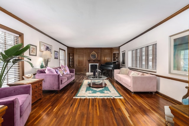 living area with baseboards, a fireplace, dark wood finished floors, and crown molding