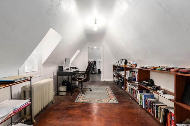 office featuring radiator heating unit, vaulted ceiling, and wood finished floors