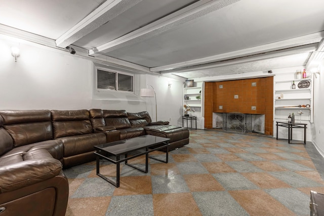 living room with beam ceiling and a fireplace