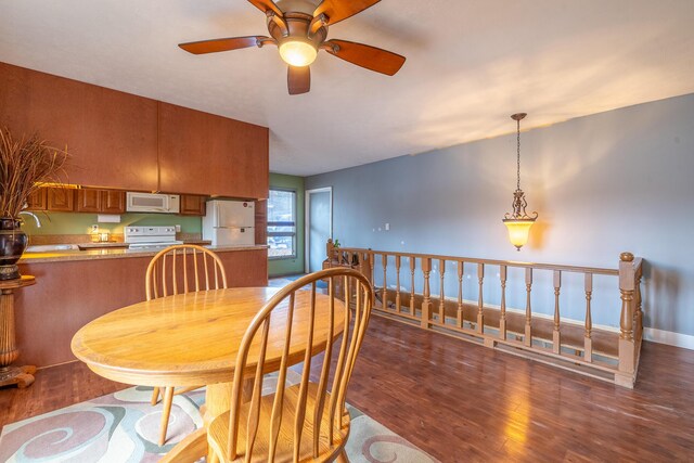 dining room with baseboards and wood finished floors