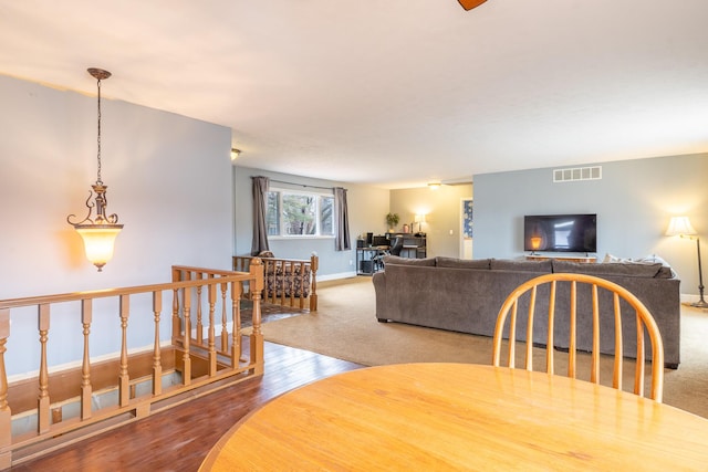 dining room with wood finished floors, visible vents, and baseboards