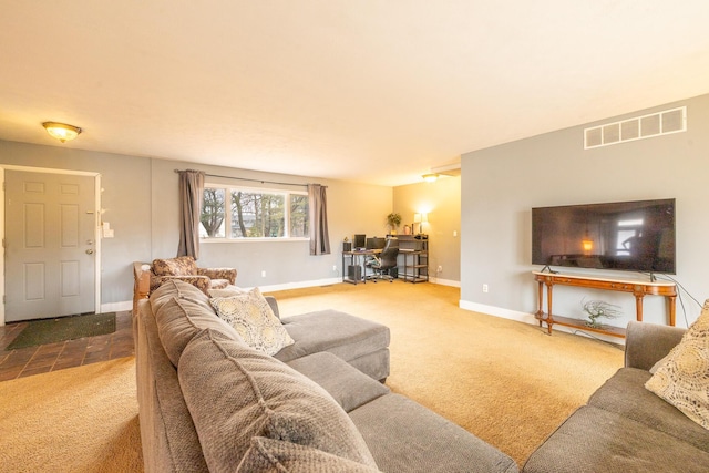 living room featuring carpet flooring, visible vents, and baseboards