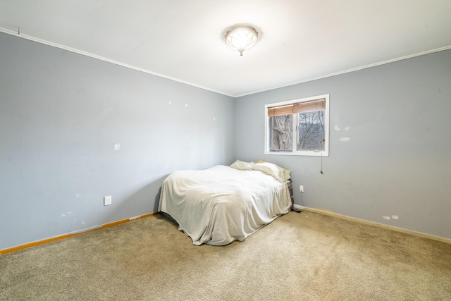 bedroom with crown molding, carpet flooring, and baseboards