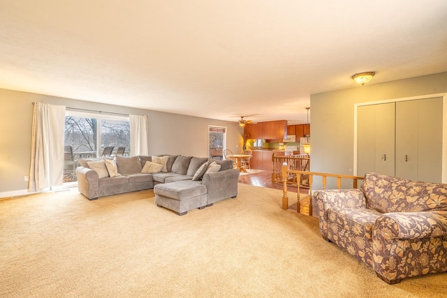 living room with light carpet and baseboards