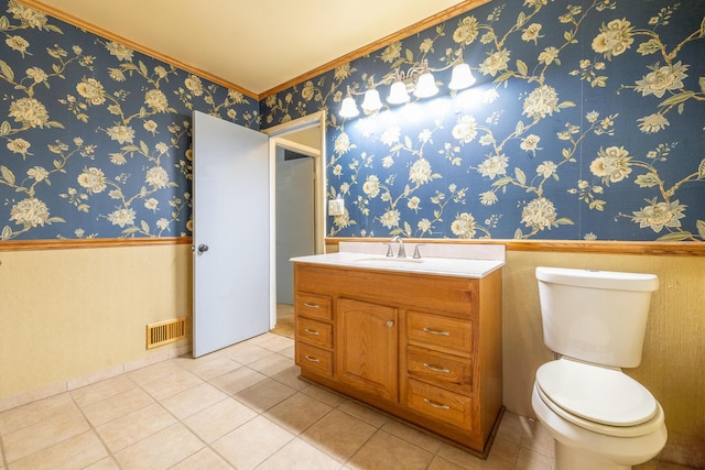 bathroom with a wainscoted wall, visible vents, toilet, and wallpapered walls