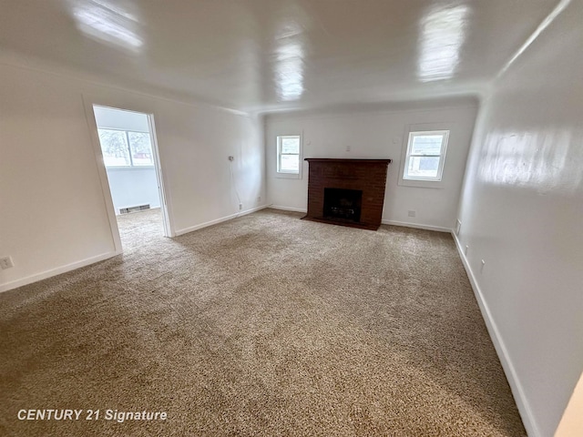 unfurnished living room featuring a brick fireplace, carpet flooring, visible vents, and baseboards