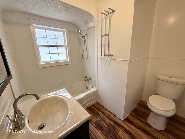 full bathroom featuring shower / tub combination, vanity, toilet, and wood finished floors