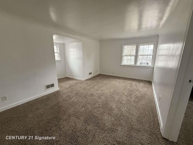 unfurnished room featuring carpet floors, baseboards, and visible vents