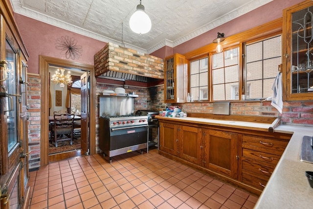 kitchen with an ornate ceiling, light countertops, and brick wall