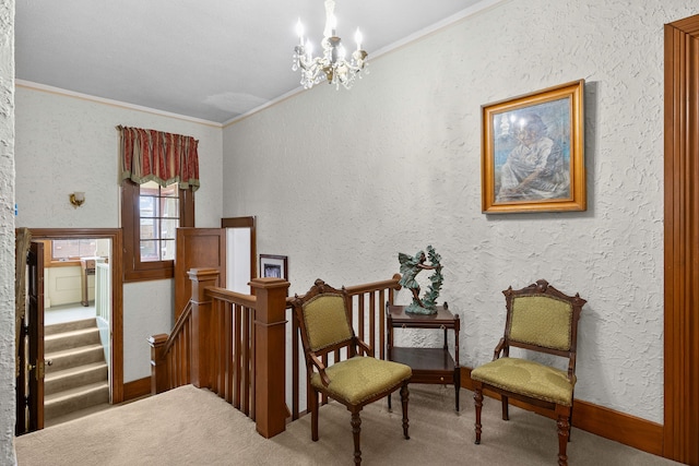 sitting room with carpet, a chandelier, ornamental molding, and a textured wall