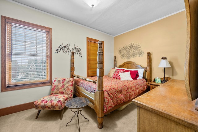 carpeted bedroom with baseboards and ornamental molding