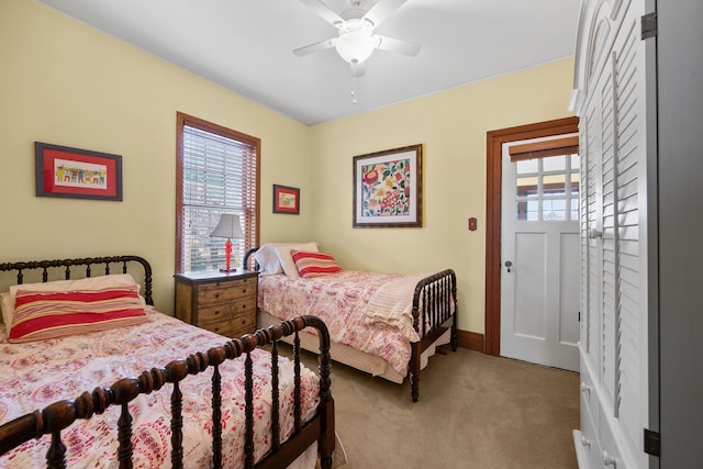 bedroom featuring light carpet, multiple windows, and a ceiling fan