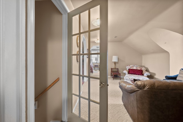 carpeted living room featuring vaulted ceiling