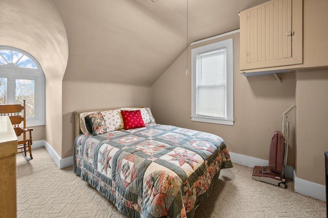 bedroom featuring light carpet, vaulted ceiling, and baseboards