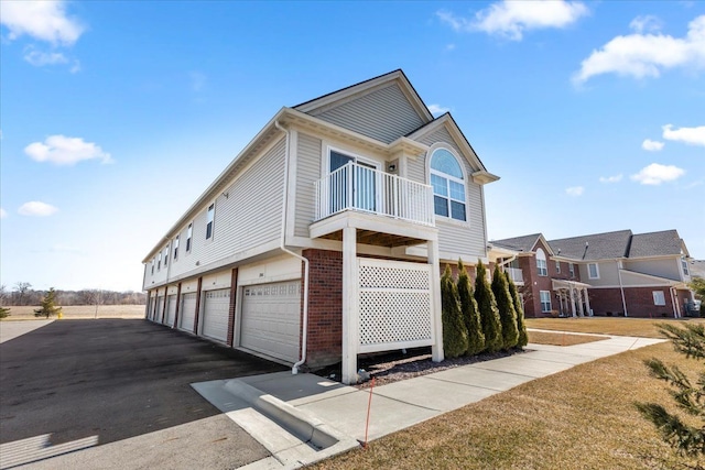 exterior space featuring brick siding and a balcony