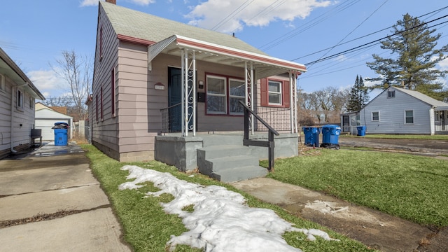 12861 Georgiana Ave, Warren, MI 48089 - bungalow-style house with a porch, a shingled roof, an outdoor structure, a chimney, and a front yard