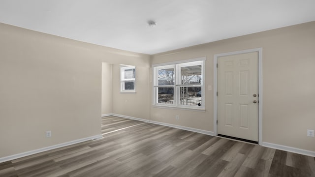 unfurnished room with wood finished floors and baseboards