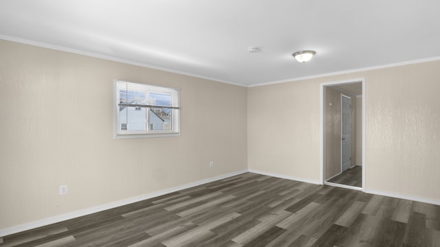 empty room featuring crown molding, baseboards, and dark wood-style flooring