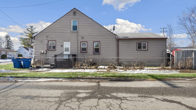 back of house with a fenced front yard