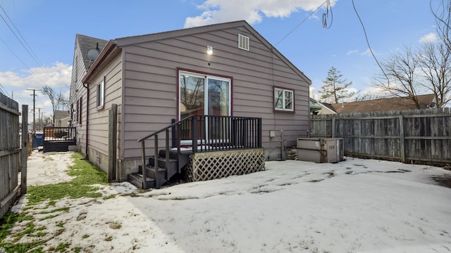 rear view of house featuring fence