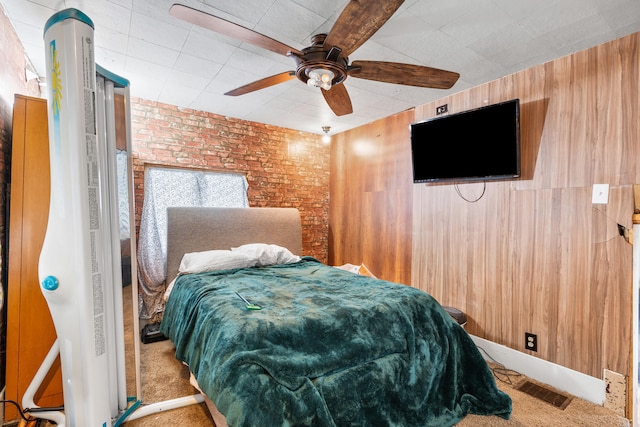 bedroom with carpet floors, visible vents, brick wall, and a ceiling fan