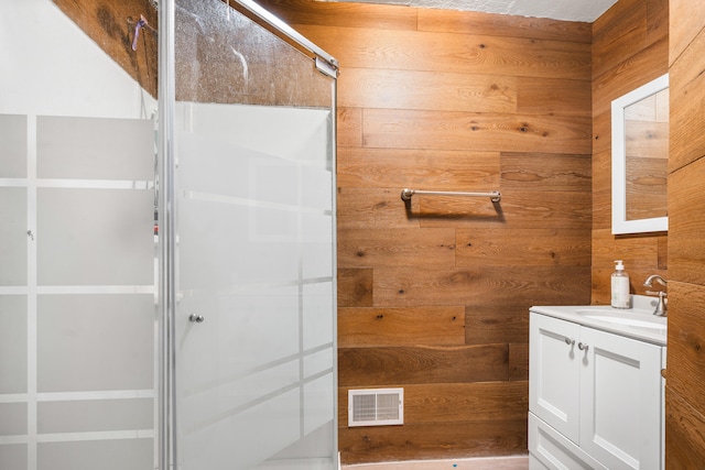 full bathroom with wood walls, visible vents, and a stall shower