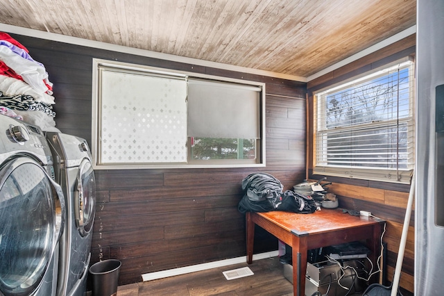 interior space featuring laundry area, wood ceiling, wood finished floors, independent washer and dryer, and wood walls