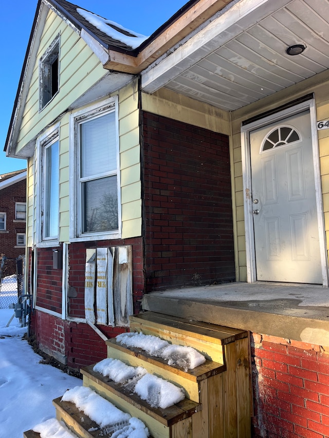 property entrance with brick siding