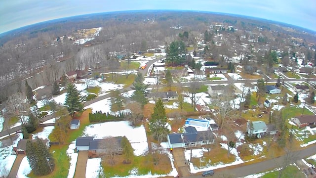 snowy aerial view with a forest view and a residential view