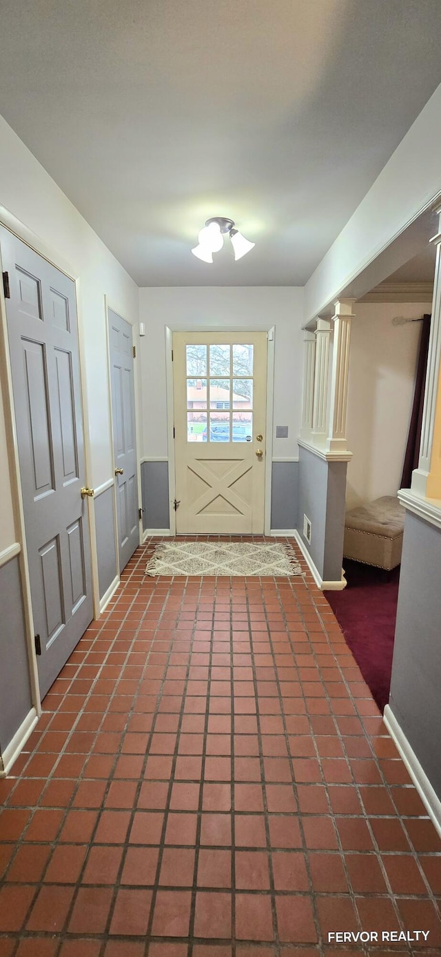 entryway with tile patterned flooring and baseboards