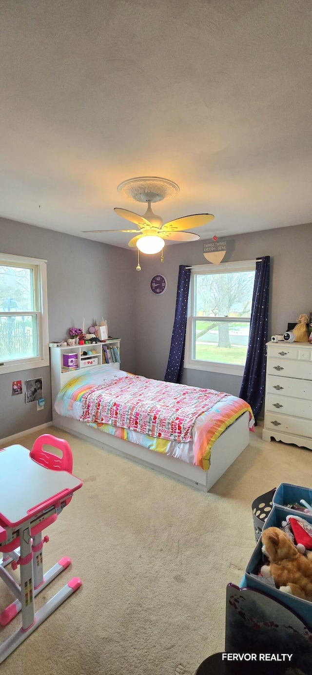 carpeted bedroom featuring a ceiling fan