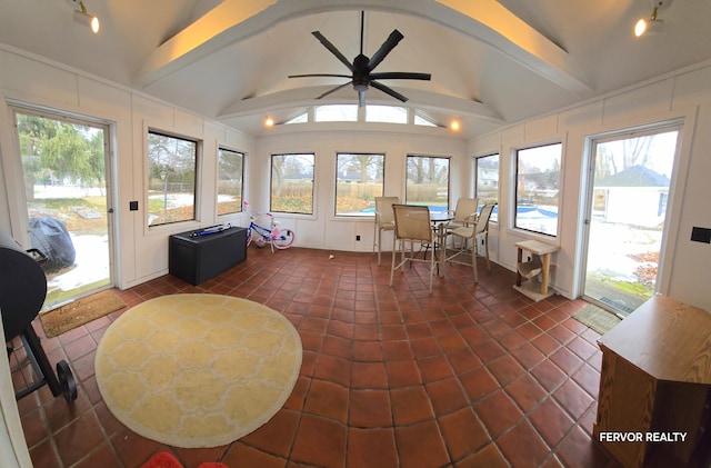 sunroom featuring vaulted ceiling with beams and ceiling fan