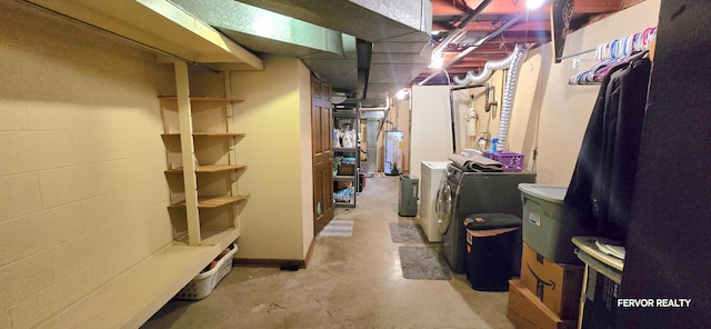 unfinished basement with washer and dryer, gas water heater, and concrete block wall