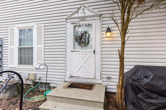 doorway to property featuring central air condition unit