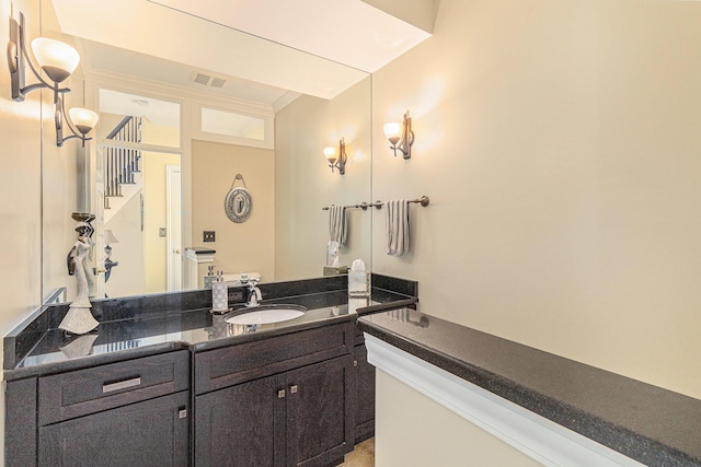 bathroom featuring vanity, visible vents, and crown molding