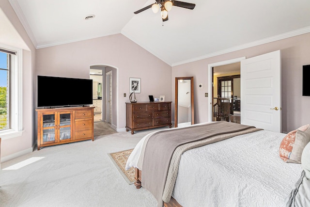 bedroom with arched walkways, crown molding, light colored carpet, vaulted ceiling, and baseboards