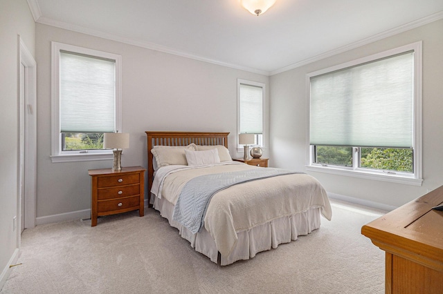 bedroom with crown molding, multiple windows, baseboards, and light colored carpet