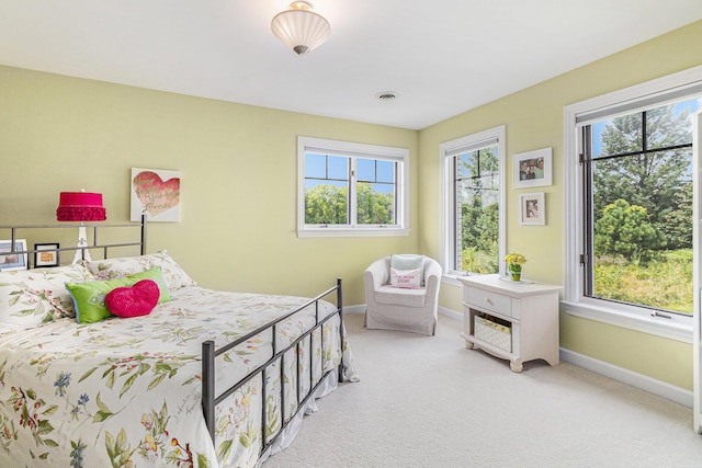 carpeted bedroom with multiple windows, visible vents, and baseboards