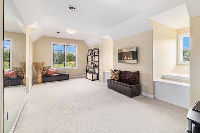 sitting room featuring carpet, visible vents, vaulted ceiling, and baseboards