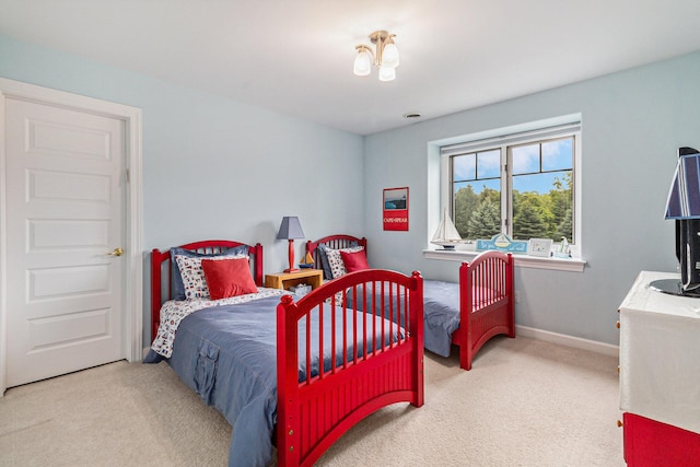 carpeted bedroom with baseboards