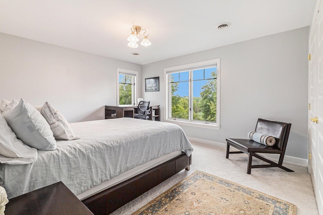 carpeted bedroom with baseboards and visible vents