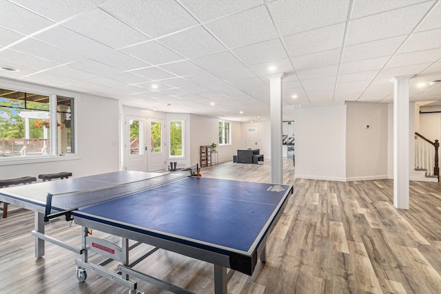 playroom with a paneled ceiling, baseboards, wood finished floors, and recessed lighting