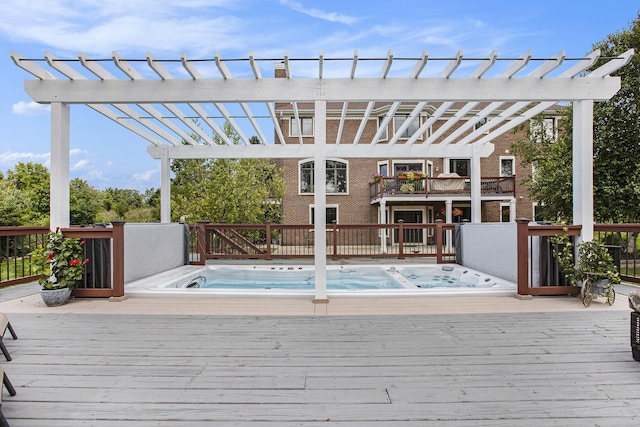 deck with hot tub deck surround and a pergola