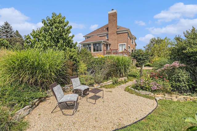 view of yard featuring a patio area and a wooden deck