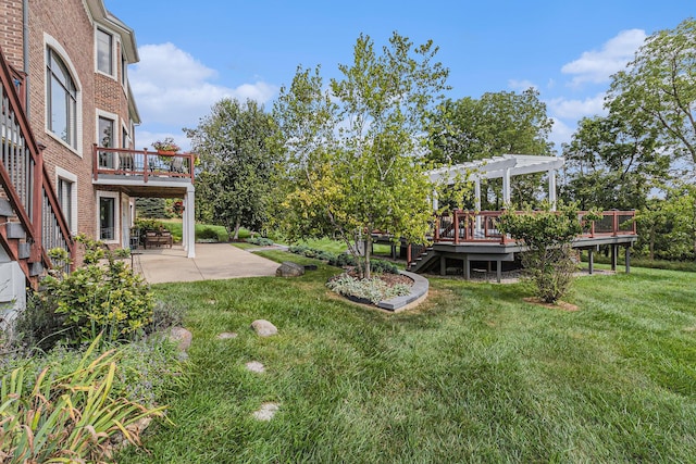 view of yard with a deck, a pergola, and a patio