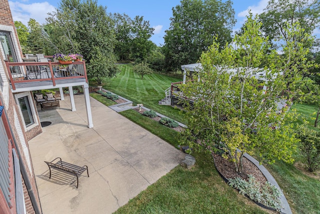 view of patio with a garden and a wooden deck