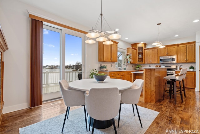 dining space with hardwood / wood-style floors, recessed lighting, visible vents, and baseboards