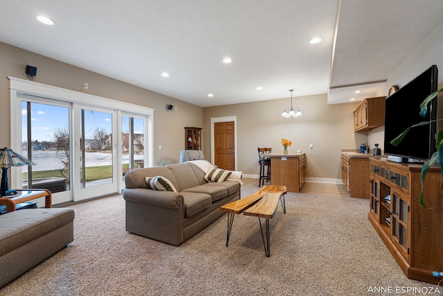 living room featuring recessed lighting, baseboards, and an inviting chandelier